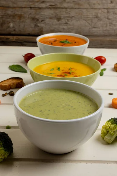 Vertical Image Bowls Carrot Broccoli Tomato Soups White Wood Copy — Stock Photo, Image