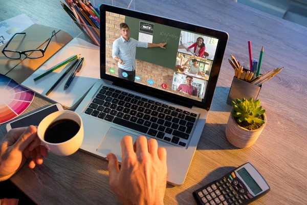 Hands of man using laptop for video call, with smiling diverse elementary school pupils on screen. communication technology and online education, digital composite image.