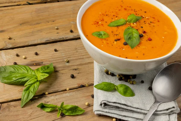 Horizontal Image Bowl Tomato Soup Basil Leaves Spoon Napkin Wood — Stock Photo, Image