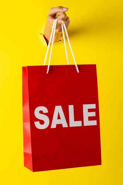 Composition Hand Holding Shopping Bag Sale Text Yellow Background Retail — Stock Photo, Image