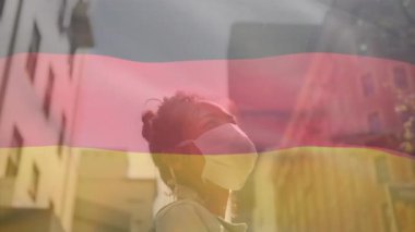 Afro-Amerikan kadın üzerinde sallanan Alman bayrağının animasyonu. Şehir caddesinde maske takıyor. covid 19 salgın konsepti boyunca dijital olarak üretilen küresel sağlık önlemleri.