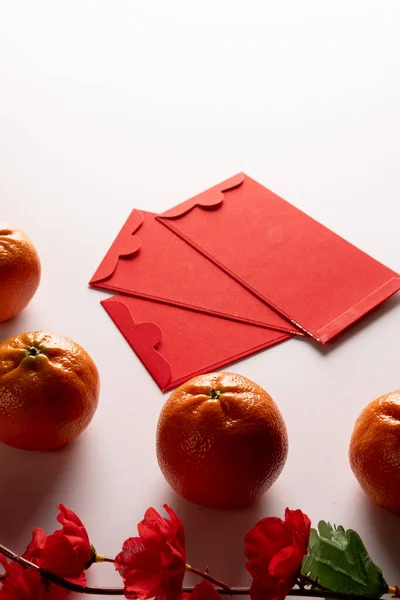 Composition Red Flowers Envelopes Oranges White Background Chinese New Year — Stock Photo, Image