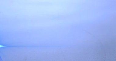 Parlayan ışıkla mavi suya düşen suyun animasyonu. Hareket ve ışık konsepti dijital olarak oluşturulmuş video.