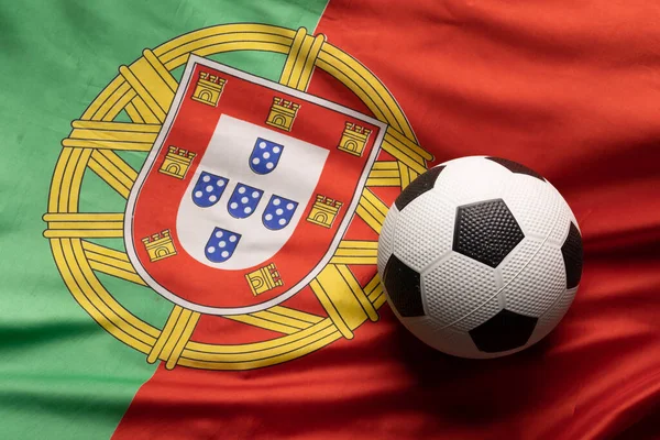 Composition of football over national flag of portugal. Sport, movement, training and active lifestyle concept.