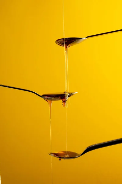 Vertical Image Maple Syrup Dripping Three Spoons Yellow Background Copy — Stock Photo, Image