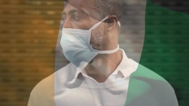 Animace Vlajky Slonovinového Pobřeží Vlnící Nad Africkým Američanem Obličejovou Maskou — Stock video