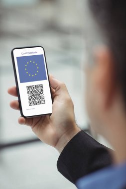 Elinde kovanlı 19 aşılı pasaportlu akıllı telefon tutan adam. küresel covid 19 salgın konsepti dijital olarak oluşturulmuş video.