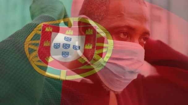 Animación Bandera Portugal Ondeando Sobre Hombre Afroamericano Con Máscara Facial — Vídeo de stock