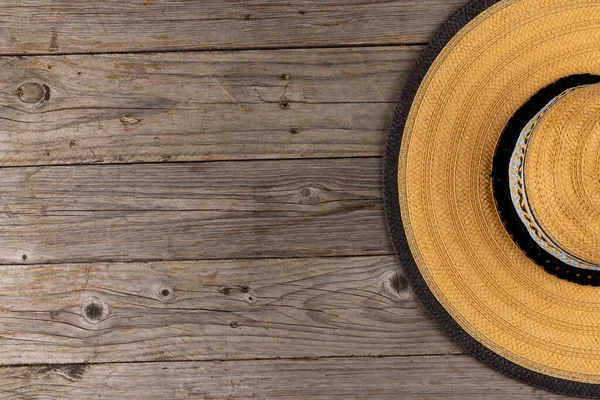Image of straw hat lying on wooden surface. Clothes, textiles, fashion, style and outfit concept.