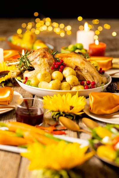 Close up of thanksgiving table with roast turkey, potatoes, candles and autumn decoration. Thanksgiving, autumn, fall, american tradition and celebration concept.