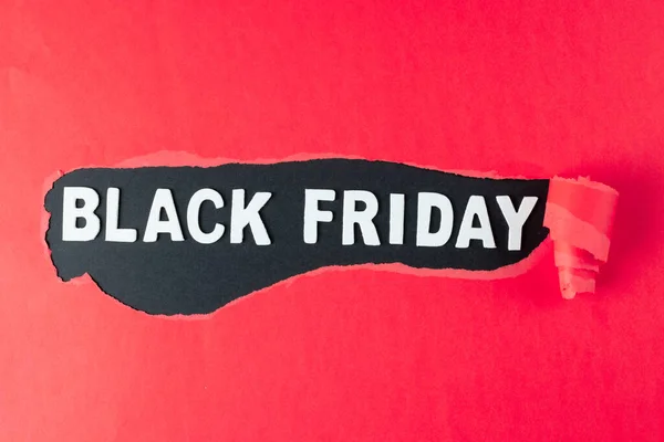 Composition of pink paper and black friday text on black background. Retail, shopping and black friday concept.
