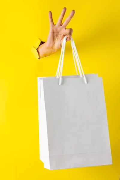 Composition Hand Holding Shopping Bags Yellow Background Retail Shopping Black — Stock Photo, Image