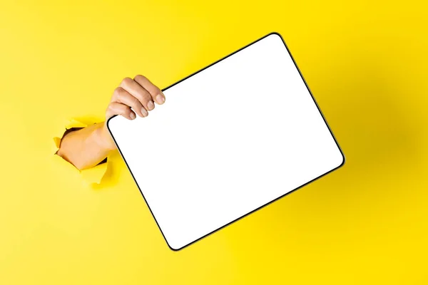 Composition of hand holding board with copy space on yellow background. Retail, shopping and black friday concept.