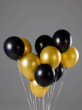 Gri arka planda yeni yıl balonlarının yakın plan kompozisyonu. Yeni yıl partisi, kutlama ve uzay konseptini kopyalama.