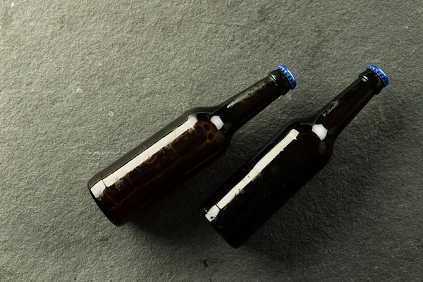 Изображение Двух Тёмных Пивных Бутылок Голубыми Колпачками Лежащих Доске Копировальным — стоковое фото