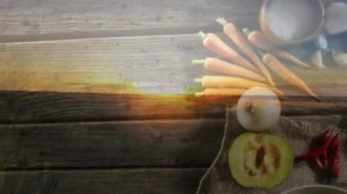 Ahşap arka planda sebzelerin üzerindeki manzaranın animasyonu. Sonbahar geleneği ve dijital olarak üretilen video konsepti.