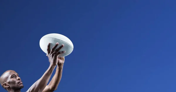 Zusammensetzung Eines Männlichen Rugbyspielers Der Einen Rugbyball Auf Blauem Hintergrund — Stockfoto