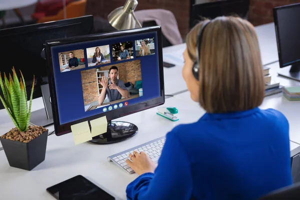 Businesswoman Wearing Headphones Sitting Desk Using Computer Having Video Call — Stock Photo, Image