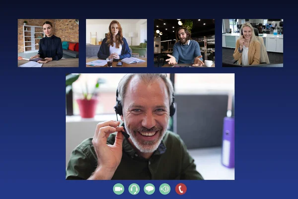 Diverse businesswomen and businessmen displayed on computer screen during video call. social distancing communication technology workplace during covid 19 pandemic.