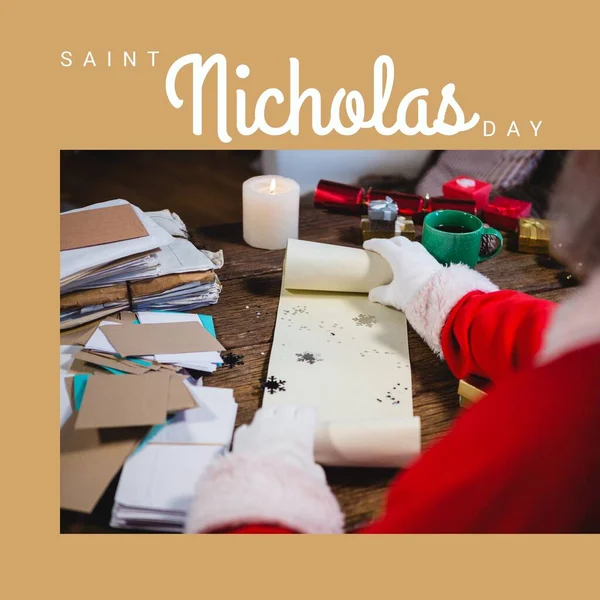 Composition of saint nicholas day text over santa claus holding scroll. Saint nicholas day, christmas festivity, tradition and celebration concept.