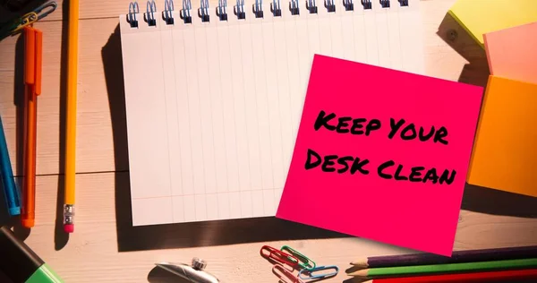 Composite of keep your desk clean text on sticky note and high angle view of office supplies. Desk, stationery, hygiene, awareness, celebration concept.