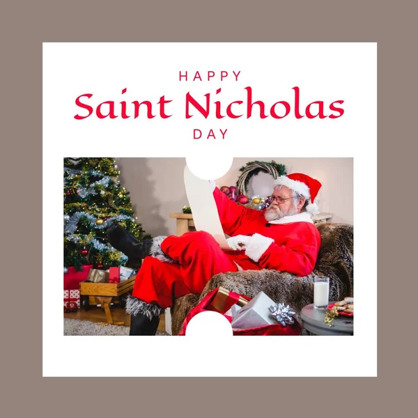 Composition of saint nicholas day text over santa claus reading scroll. Saint nicholas day, christmas festivity, tradition and celebration concept.