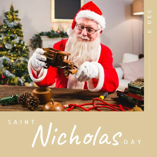 Composition of saint nicholas day text over santa claus holding car model. Saint nicholas day, christmas festivity, tradition and celebration concept.