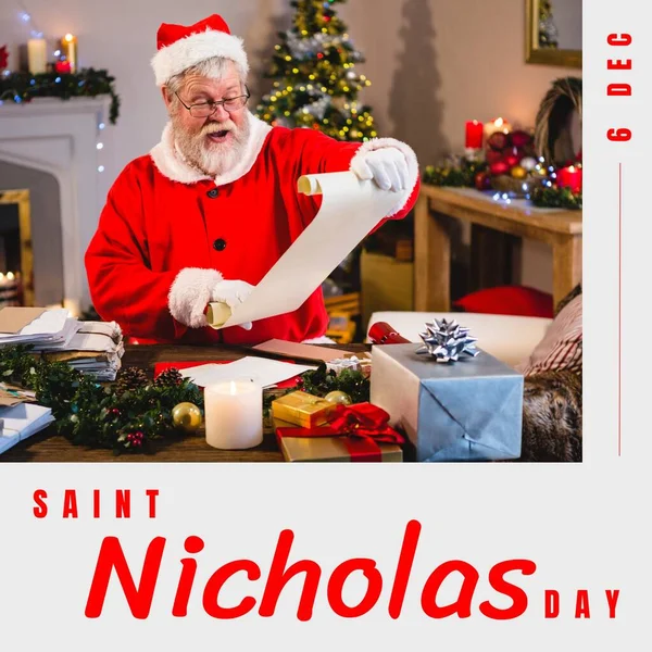 Composition of saint nicholas day text over santa claus holding scroll. Saint nicholas day, christmas festivity, tradition and celebration concept.