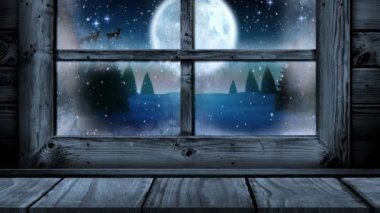 Ahşap pencere çerçevesi animasyonu. Yılbaşı karları yağıyor, dolunay ve Noel Baba 'nın kızağı dışarıda. Noel, kış, şenlik, gelenek ve dijital olarak üretilen video konsepti.