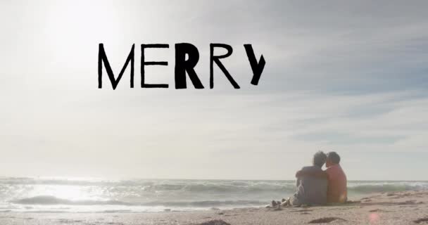 Animation Merry Xmas Text Senior Biracial Couple Beach Christmas Tradition — Stock Video