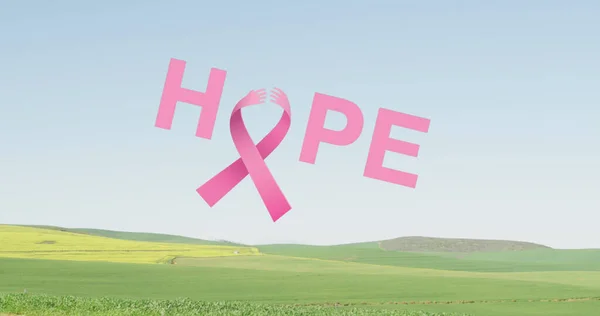 Image of pink ribbon and hope over landscape. Women health, medicine and breast cancer awareness concept.