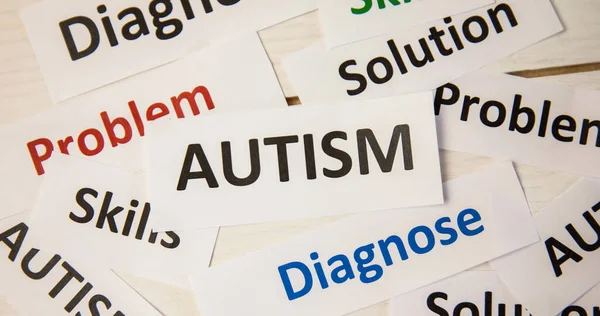 Composite of multiple white papers with medical words text. Autism, diagnose, problem, solution, medical and healthcare concept.