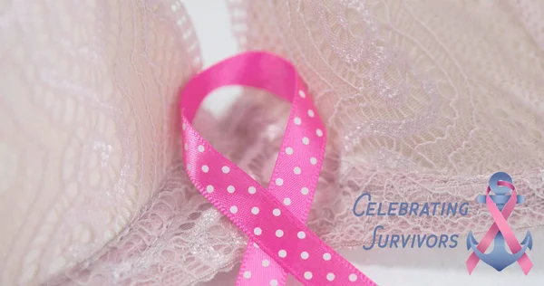 Composite of pink awareness ribbons on textured cloth and celebrating survivors text with anchor. Copy space, disease, illness, healthcare, textile, support, medical and awareness concept.