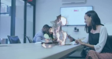 Animation of globe over diverse business people in office. Global business and digital interface concept digitally generated video.