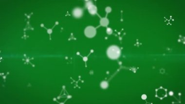 Yeşil zemin üzerinde düşen moleküllerin ve ışıkların animasyonu. Arkaplan ve anlar konsepti dijital olarak oluşturulmuş video.