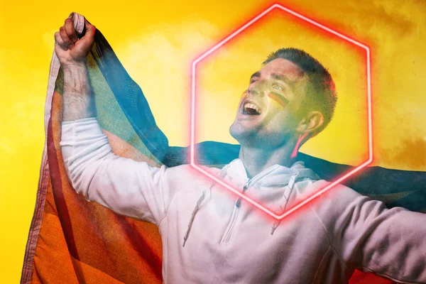 Male Caucasian Player German Flag Screaming Illuminated Hexagon Yellow Background — Stock Photo, Image