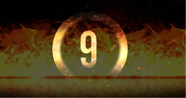 Image of ring and glowing number nine in dramatic countdown over flaming fire background. Countdown, anticipation, time and entertainment concept digitally generated image.