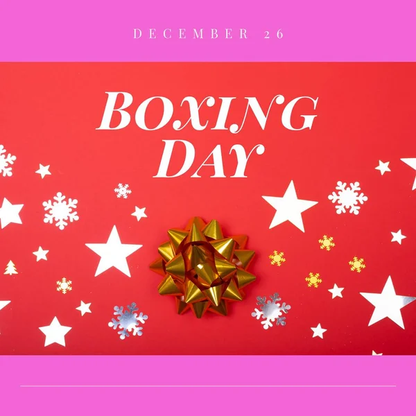 Composition of boxing day text over christmas decorations on red background. Christmas, boxing day, festivity, celebration and tradition concept digitally.