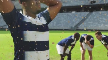 Afrika kökenli Amerikalı erkek rugby oyuncusunun üzerine düşen konfeti animasyonu. Spor, ragbi, turnuva ve zafer konsepti dijital olarak oluşturulmuş video.