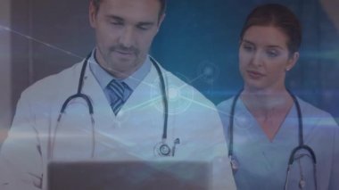 Kafkas doktorların hastanede dizüstü bilgisayarla tartıştıkları çizgilerle bağlantılı noktaların animasyonu. Dijital bileşik, çoklu pozlama, iletişim, tıbbi, sağlık ve teknoloji, takım çalışması.