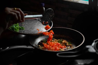 Cooking raw vegetables on the nonstick pan in the kitchen.Ingredients for cooking healthy breakfast. Asian style cooking vegetarian and healthy, selected focus, narrow depth of field.