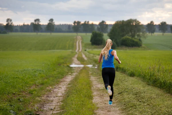 Blonde woman running in nature — Stock Photo, Image