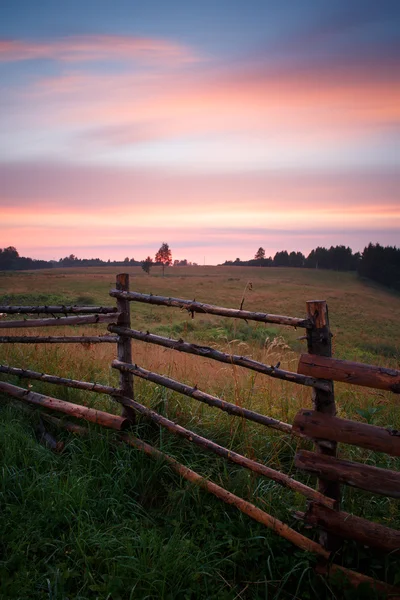 Retro styled fence on farmland Stock Image