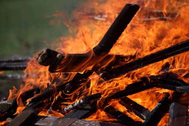Ancient traditions of burning bonfires in cemeteries, when old crosses were burned and dead relatives were remembered. Cemetery maintenance workers burn old crosses