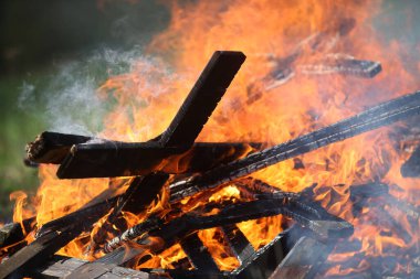 Ancient traditions of burning bonfires in cemeteries, when old crosses were burned and dead relatives were remembered. Cemetery maintenance workers burn old crosses