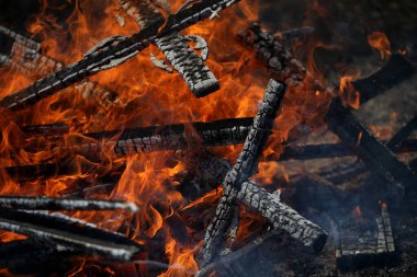 Ancient traditions of burning bonfires in cemeteries, when old crosses were burned and dead relatives were remembered. Cemetery maintenance workers burn old crosses