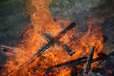 Ancient traditions of burning bonfires in cemeteries, when old crosses were burned and dead relatives were remembered. Cemetery maintenance workers burn old crosses