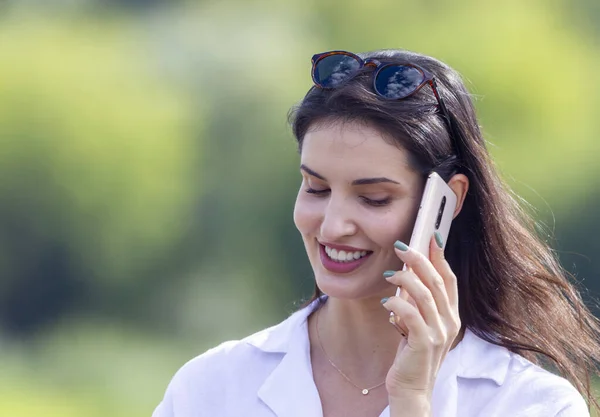 Portrait of young business woman with mobile phone outdoors