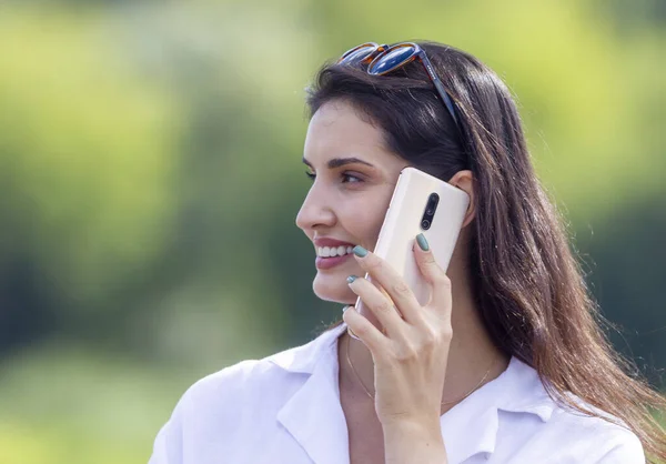 Portrait of young business woman with mobile phone outdoors