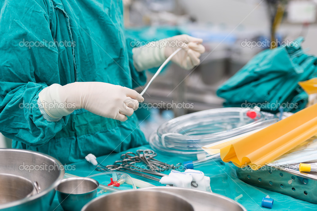 Scrub nurse preparing tools for operation — Stock Photo © chanawit 51598063